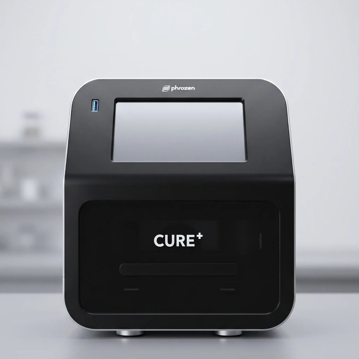 Phrozen Cure+ dental resin curing unit, front view, showing the touchscreen display and curing chamber.