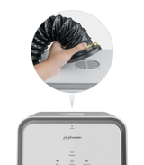 Close up of a hand attaching a black flexible exhaust hose to the top port of the Phrozen Air Purifier Max, with the full unit shown below.