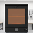 Phrozen Cure Mega S resin curing station with glowing interior on light grey workshop shelf