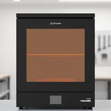 Phrozen Cure Mega S resin curing station with glowing interior on light grey workshop shelf