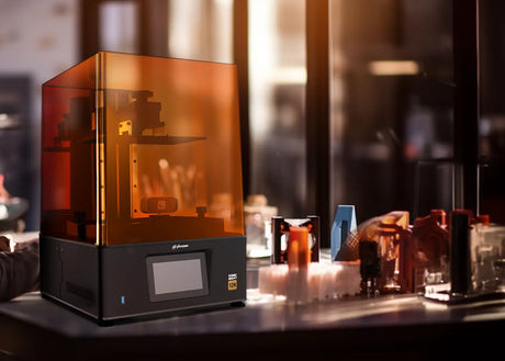 Phrozen Sonic Mighty 12K resin 3D printer on workbench with printed parts